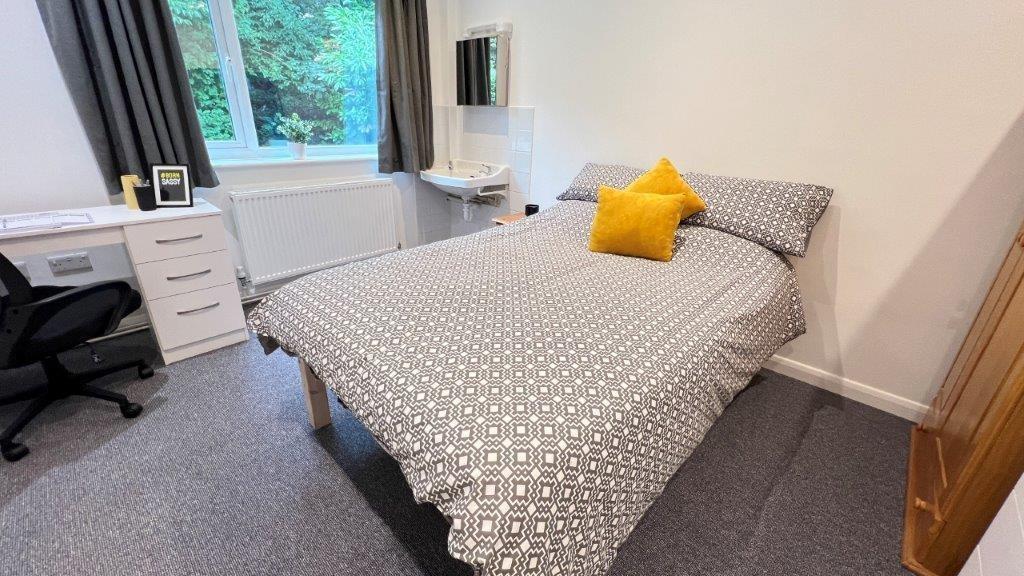 Bright, tidy bedroom with bed and study desk...