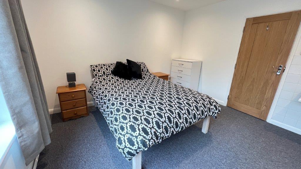 Bright double room with patterned bedding...