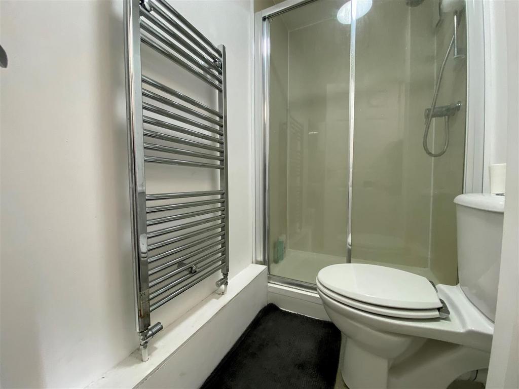 Modern bathroom with shower and heated towel ra...