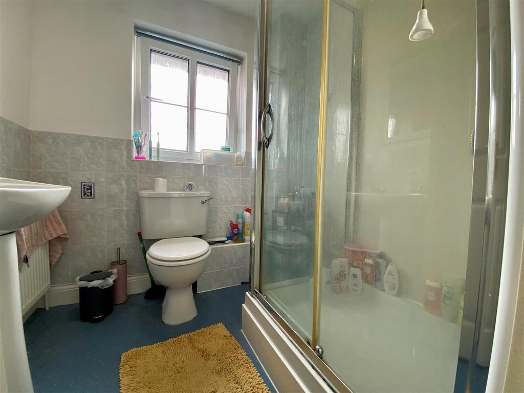 Bright bathroom with shower enclosure and sink...