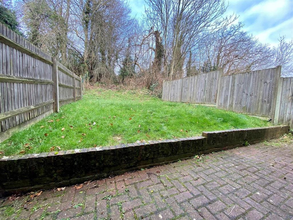 Private fenced garden with paved patio and lawn...