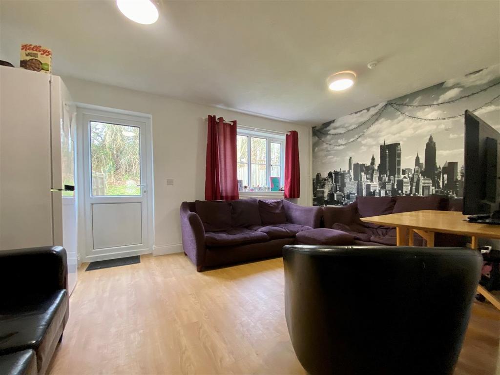 Bright lounge with sofa, cityscape feature wall...