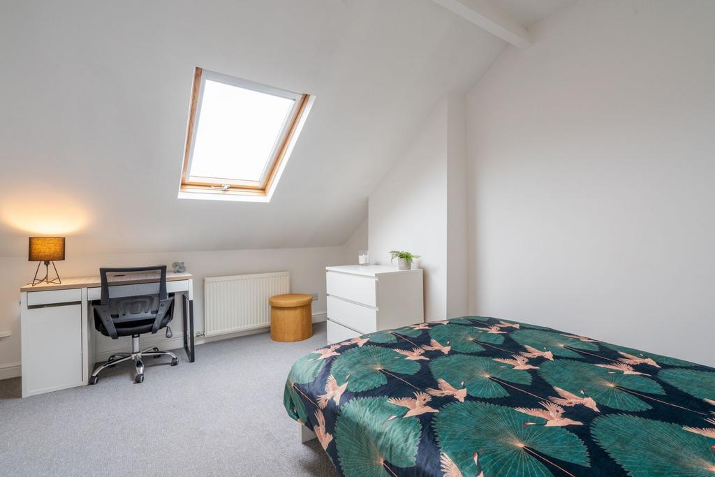 Bright and inviting bedroom with a skylight win...