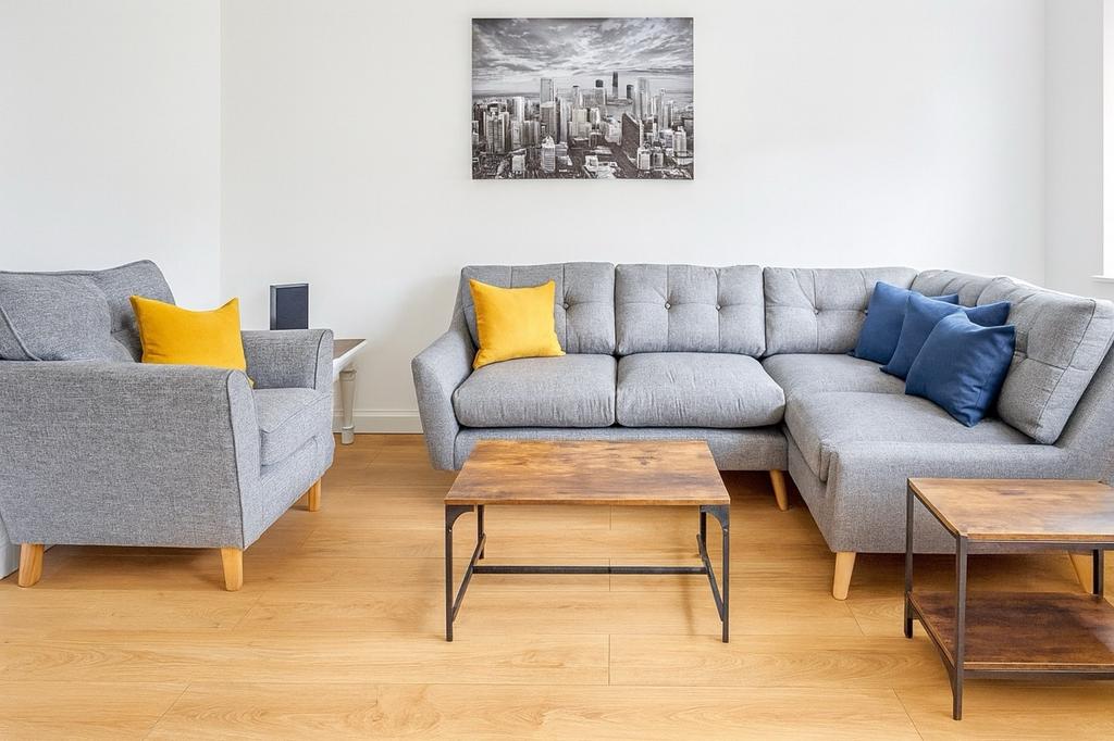 Bright contemporary living room with a grey L-s...
