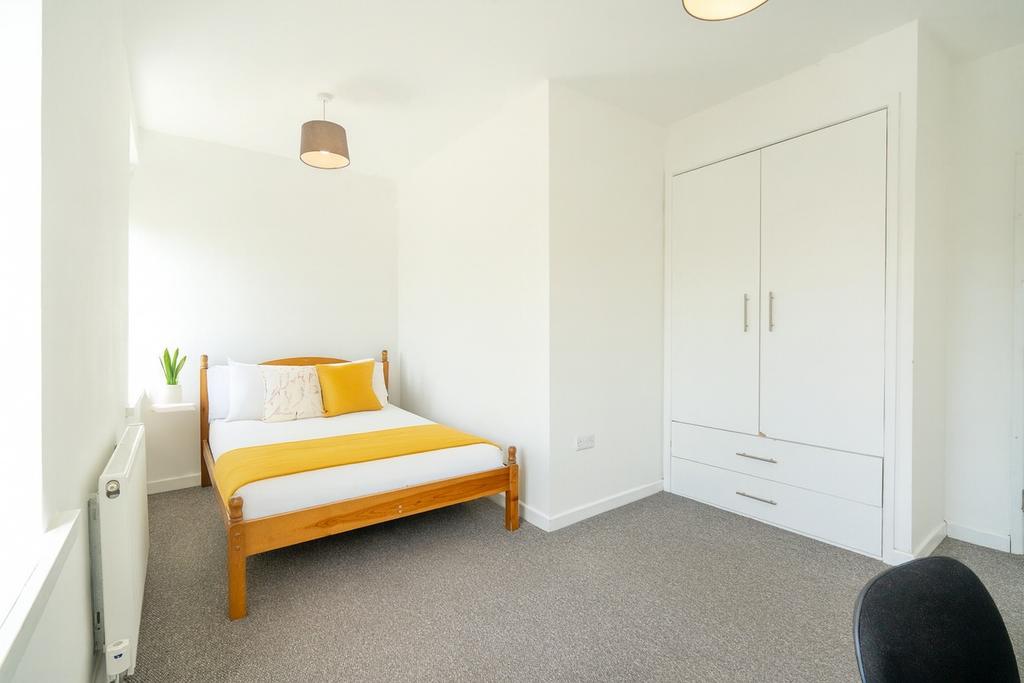Bright, freshly decorated bedroom with a wooden...