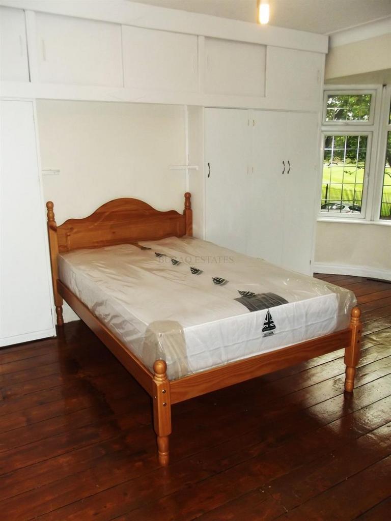 Bright bedroom with built‑in wardrobe and woode...