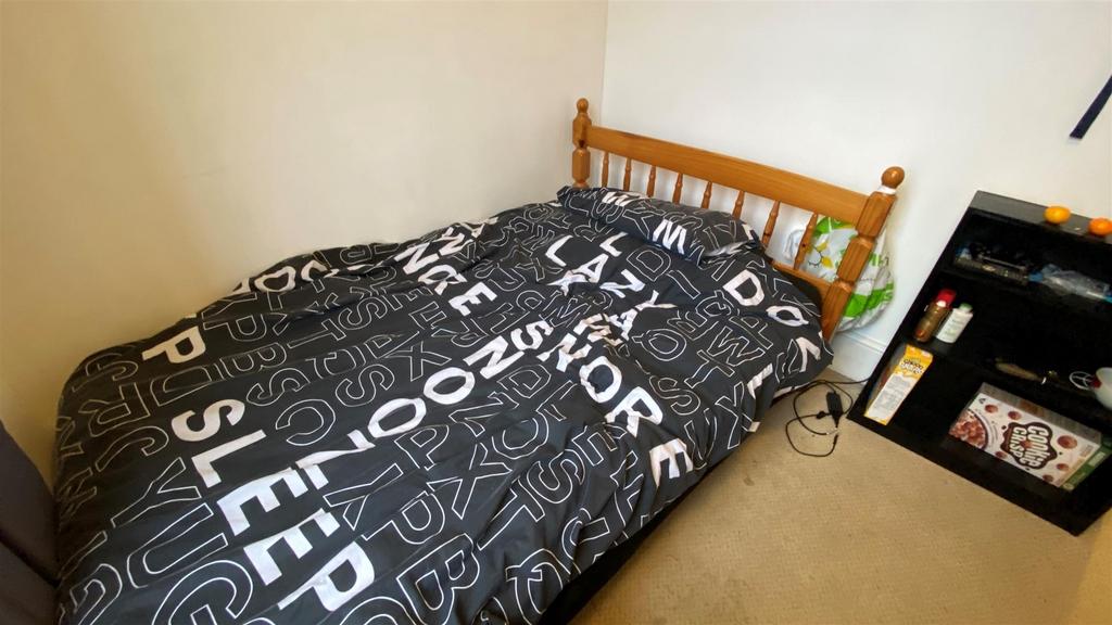 Cozy bedroom with double bed and shelving...