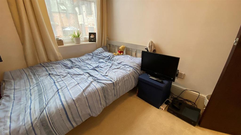 Cozy bedroom with natural light and simple layo...