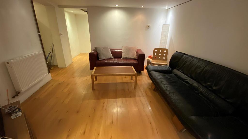 Simple lounge with wood floor and seating...