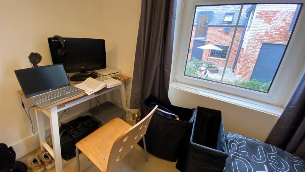 Compact lounge with desk, seating and window li...