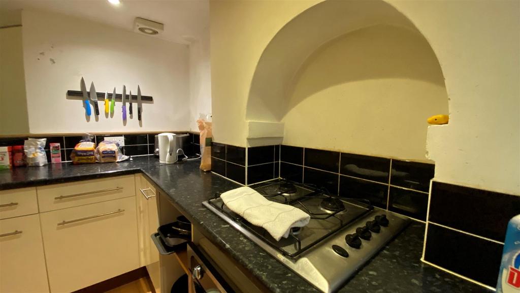 Modern kitchen with built-in hob and arch featu...