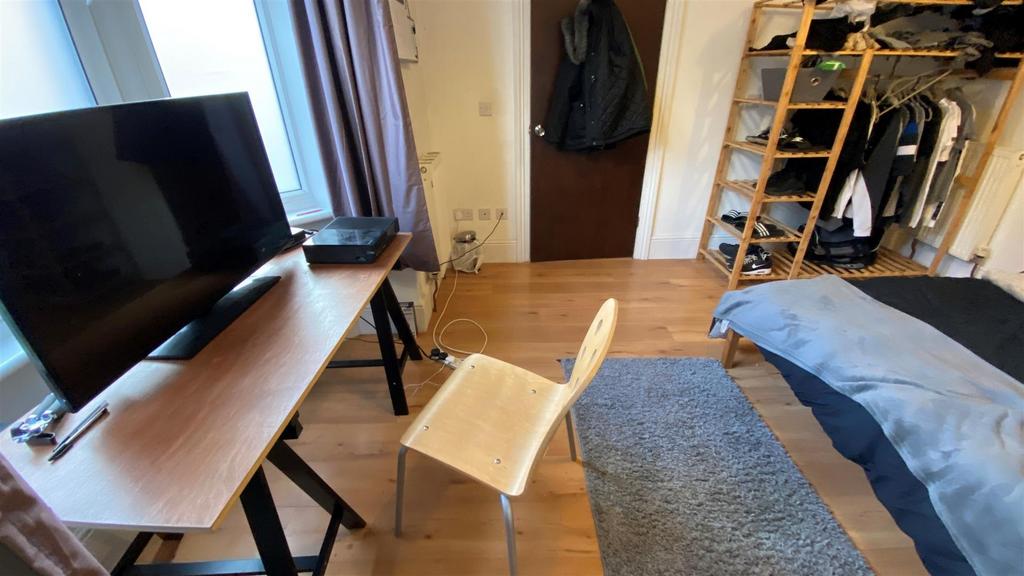 Bright bedroom with desk, TV and wardrobe...