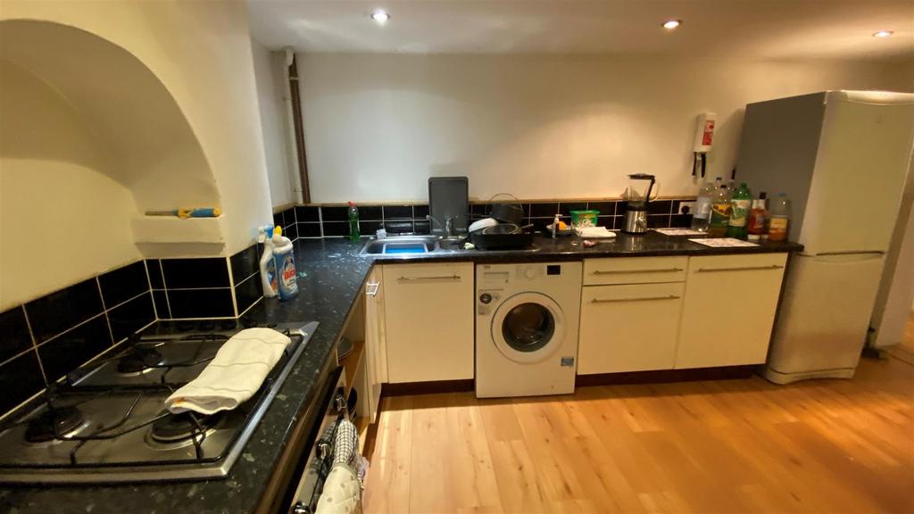 Compact modern kitchen with appliances and coun...