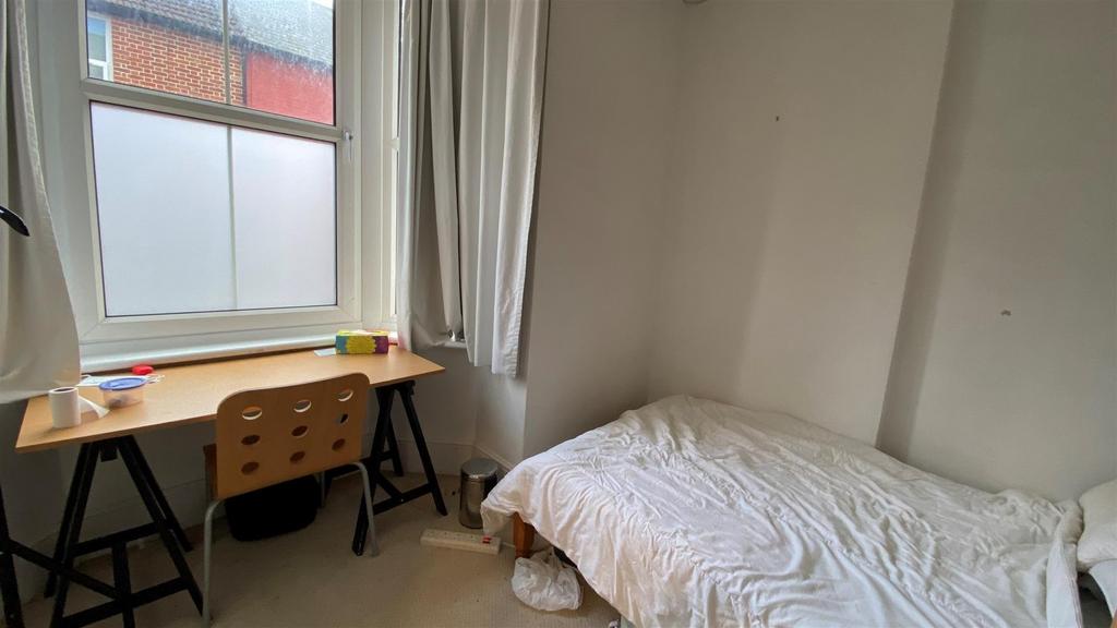 Bright room with desk by a large window...