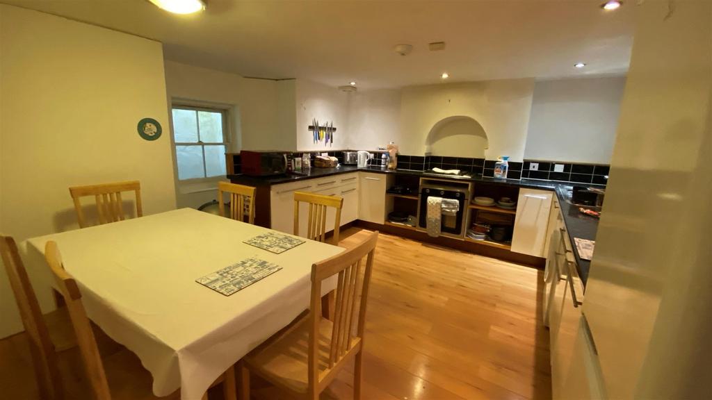 Spacious fitted kitchen with dining table and w...
