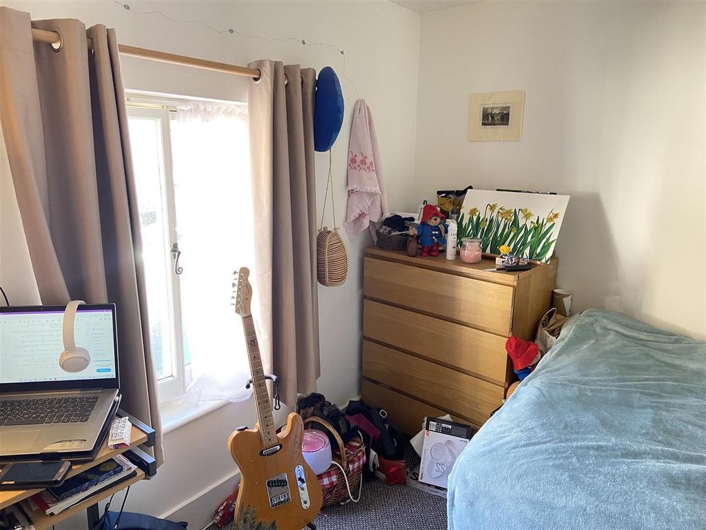 Bright room with bed, desk and storage...