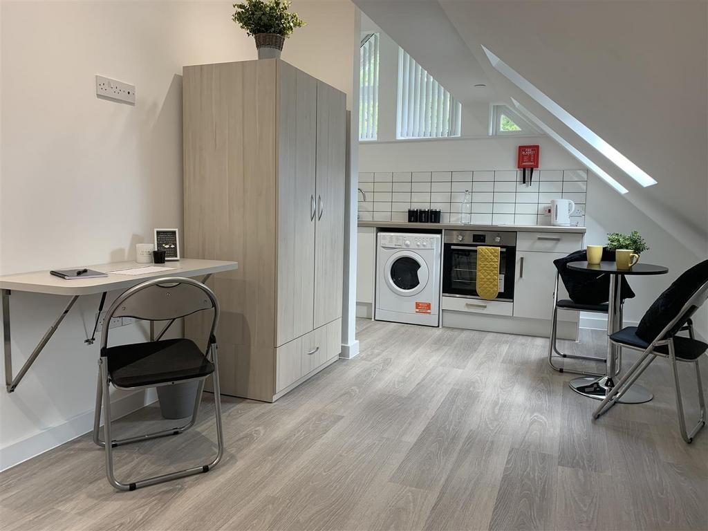 Bright angled kitchen with modern appliances...