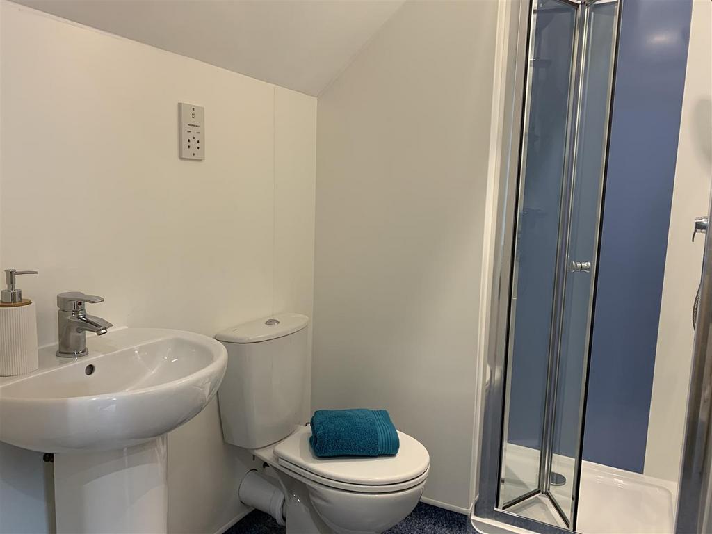 Compact bathroom with shower and fresh fixtures...