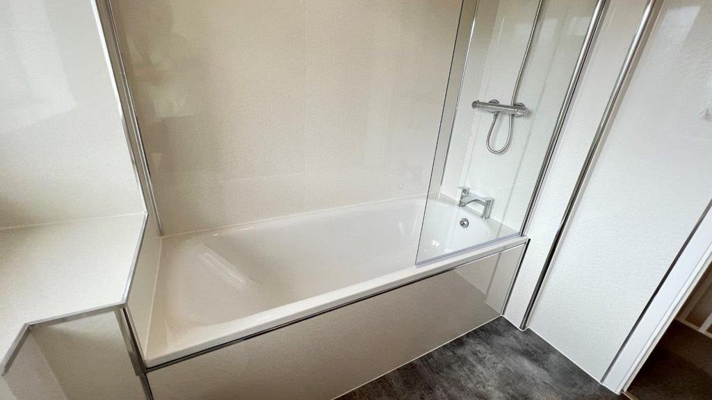 Bright modern bathroom with shower-over-bath...
