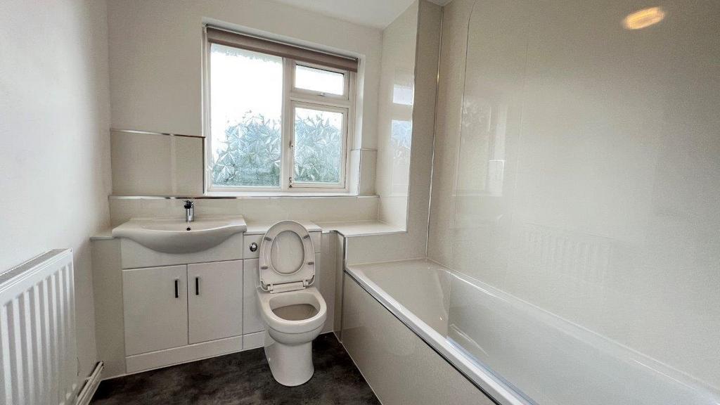 Bright bathroom with bath, sink and window...