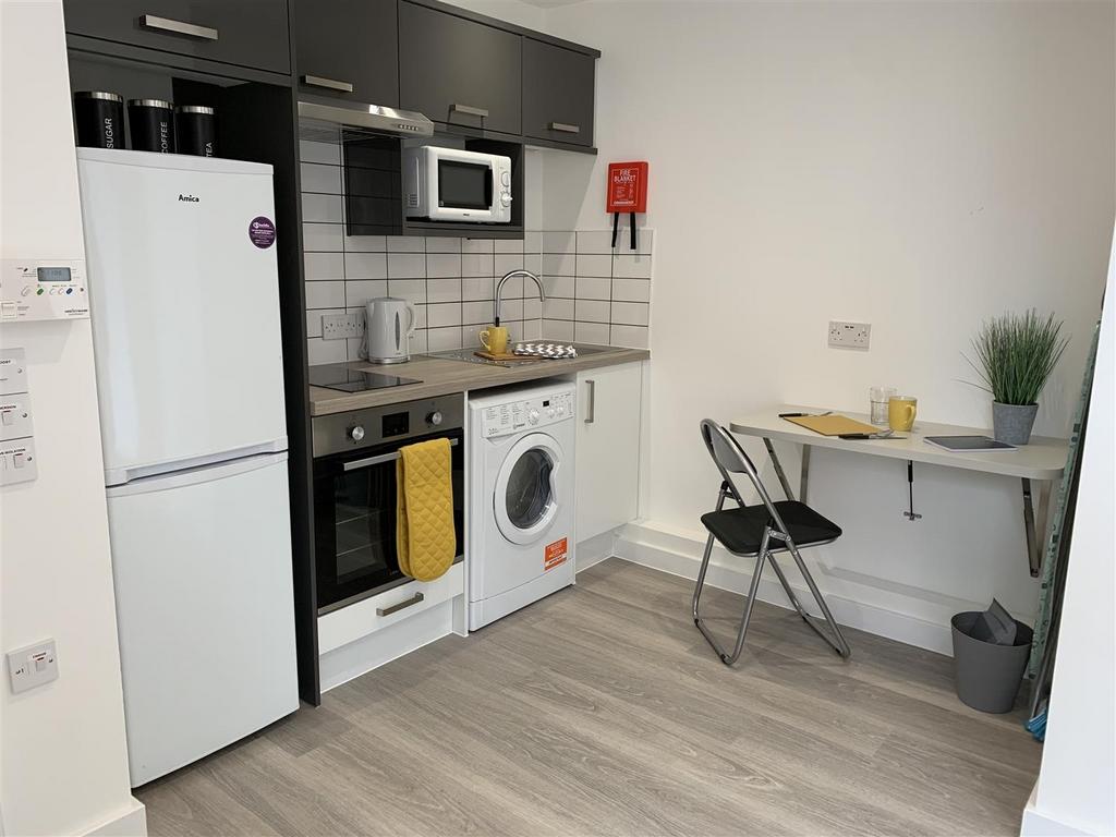 Modern kitchenette with appliances and dining n...