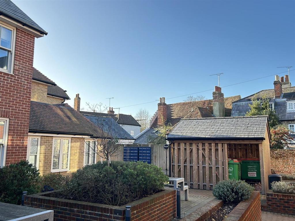 Well-kept communal courtyard with storage sheds...