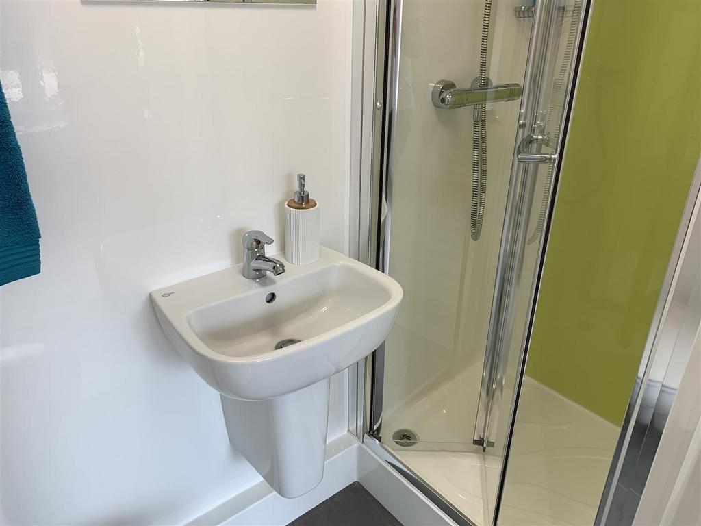 Bright modern bathroom with shower and basin...