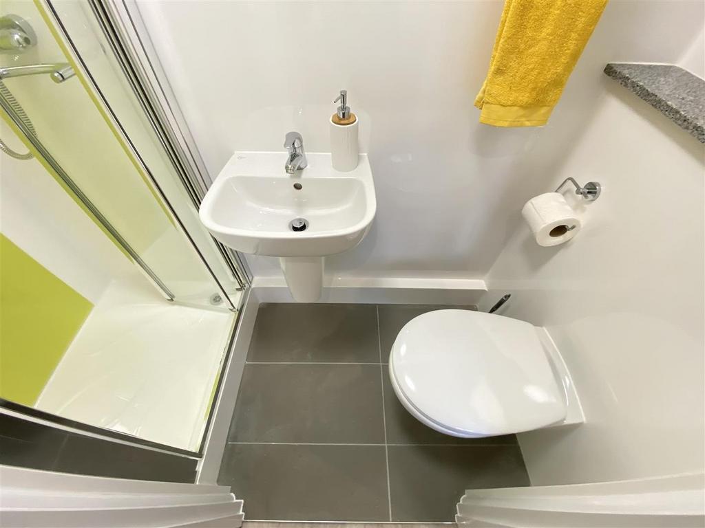 Neat modern bathroom with shower and basin...