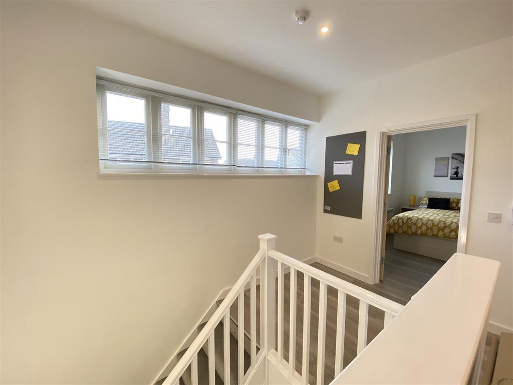 Bright upstairs landing with window and stair r...