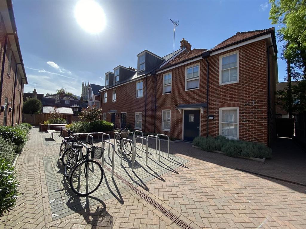 Sunny front view with bike parking and attracti...
