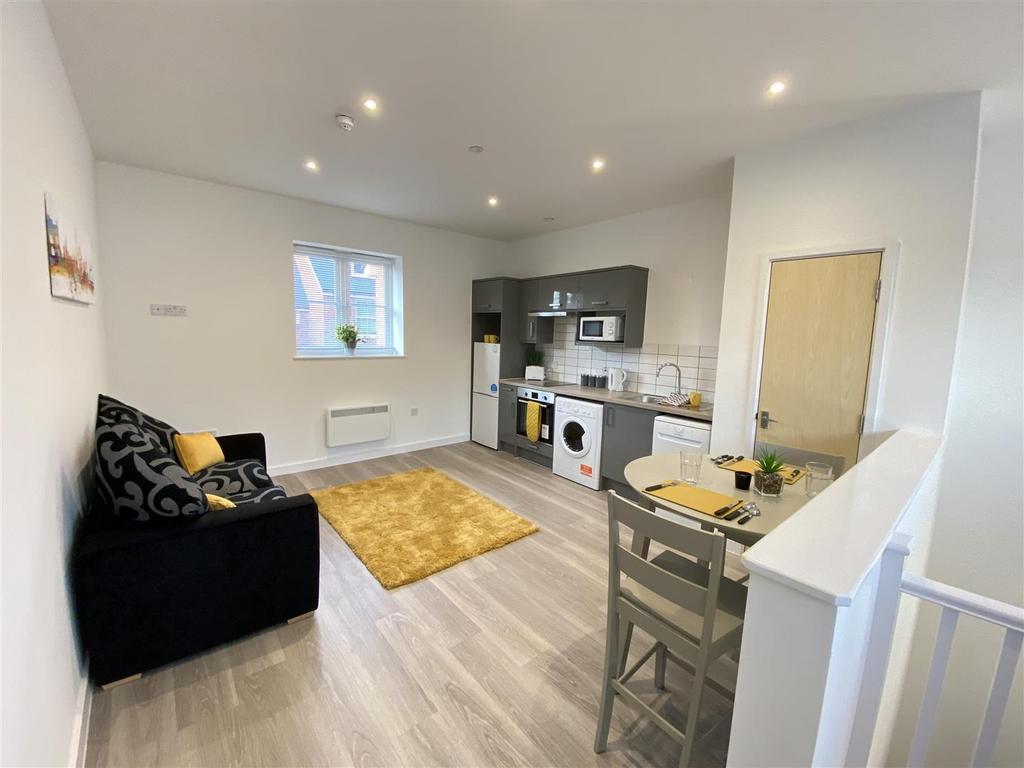 Bright open-plan lounge with modern kitchenette...