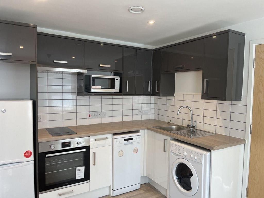 Modern fitted kitchen with glossy cabinets...
