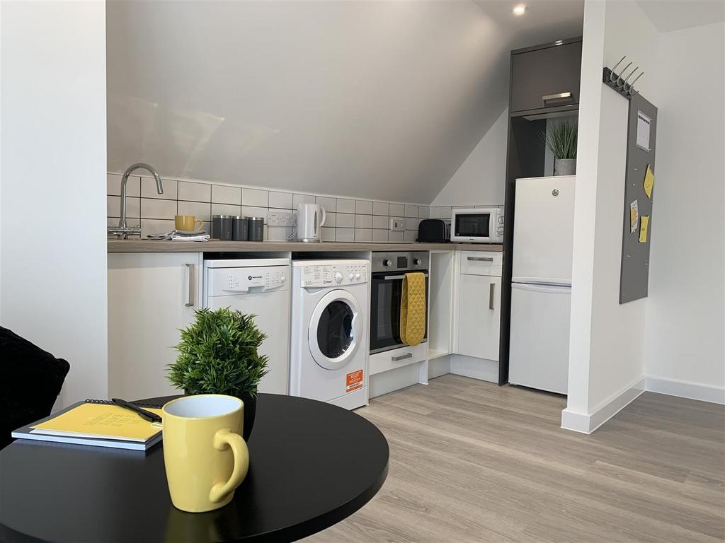 Bright modern kitchenette with appliances and e...