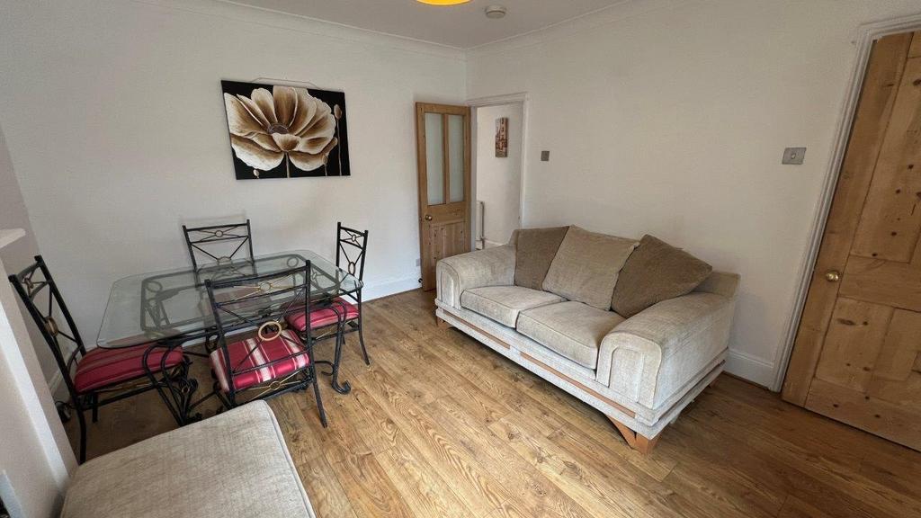Bright living area with sofa and dining set...