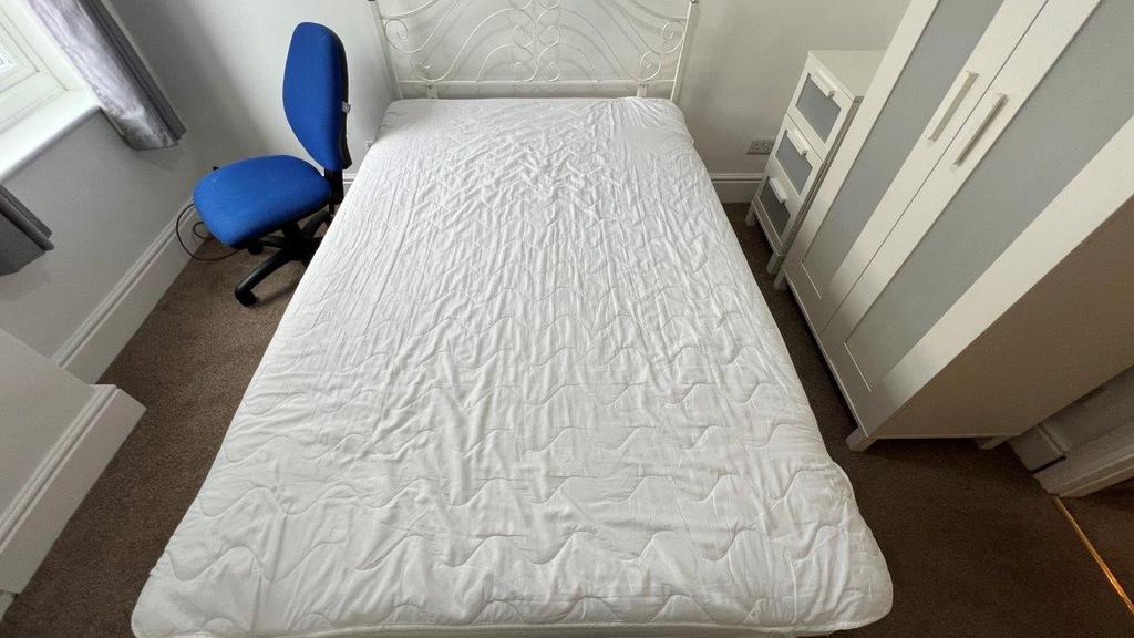 Bright room with bed, wardrobe and study chair...