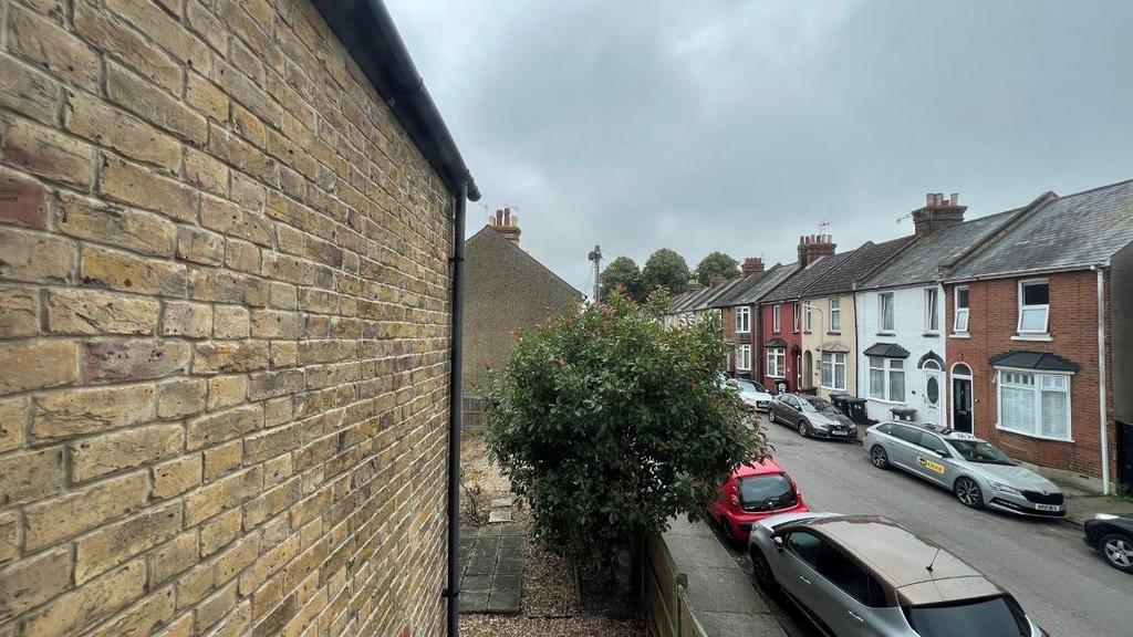 Street view of a well-kept residential terrace...