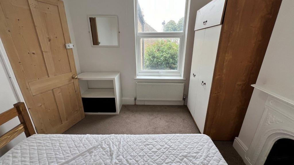 Bright bedroom with window and built-in storage...