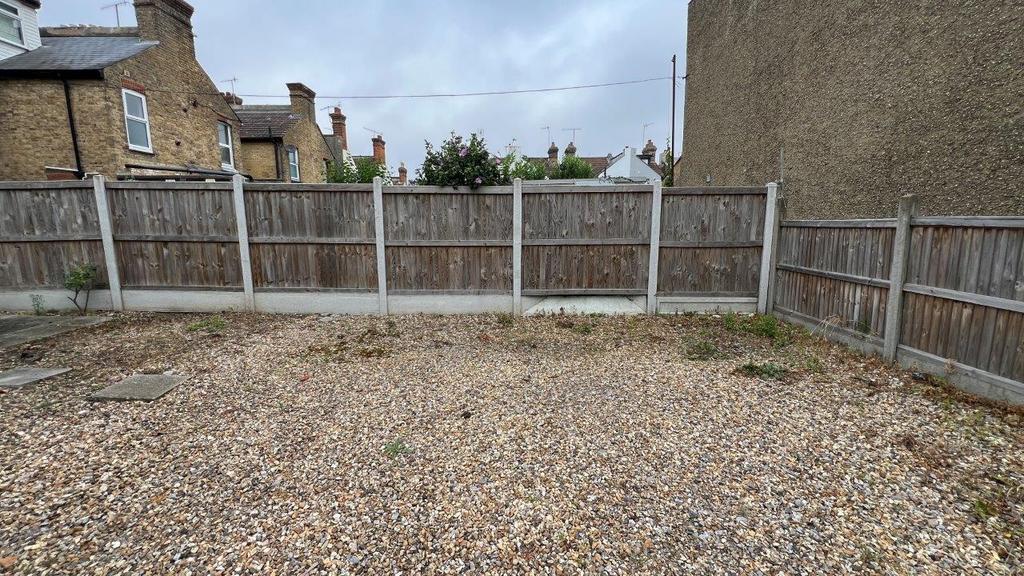 Low-maintenance private gravel garden with full...