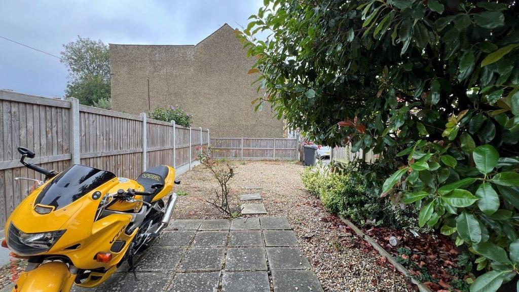 Private paved garden with secure fencing and bi...