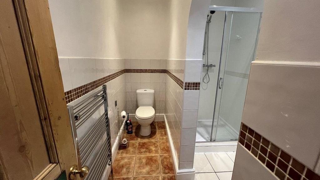 Modern bathroom with shower and tiled flooring...