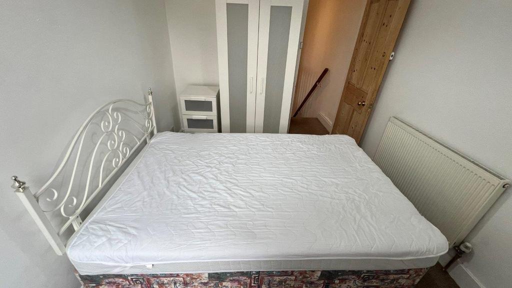 Bright double room with metal bed frame...