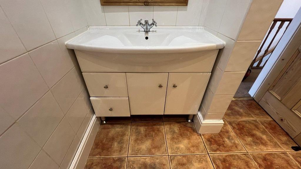 Clean bathroom basin with fitted vanity unit...