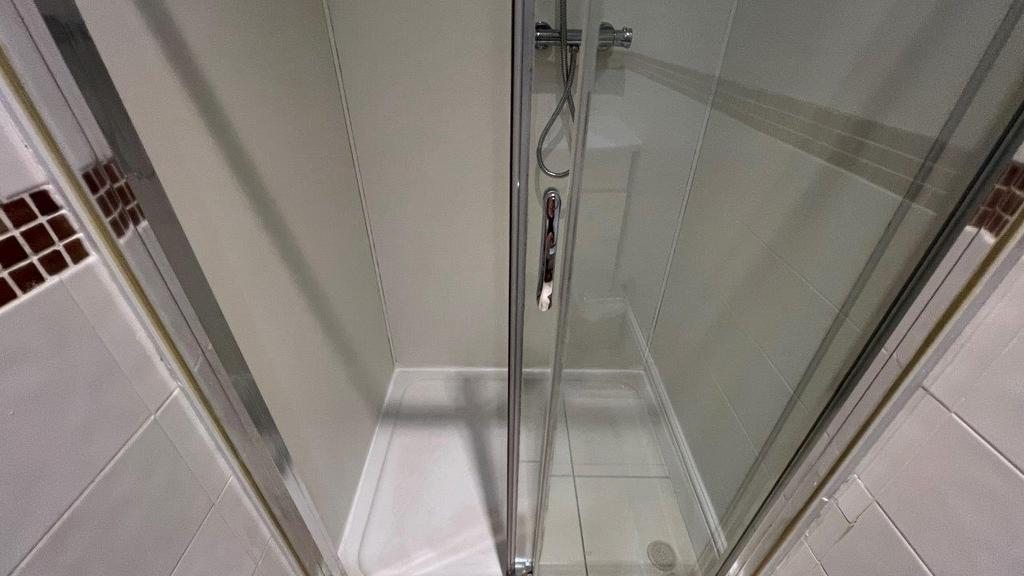 Modern glass shower with tiled surround...