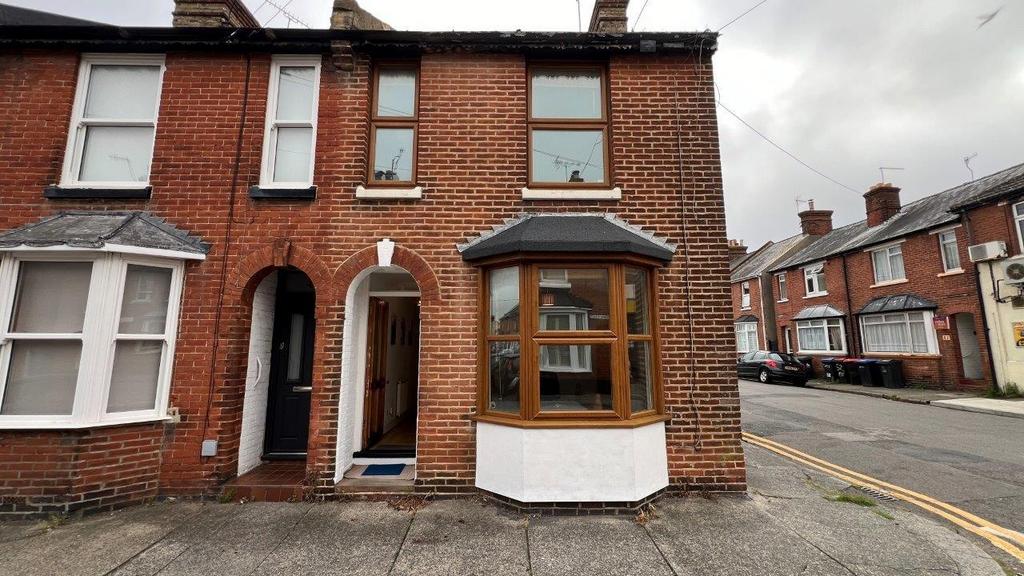 Red-brick end terrace with bay window and stree...