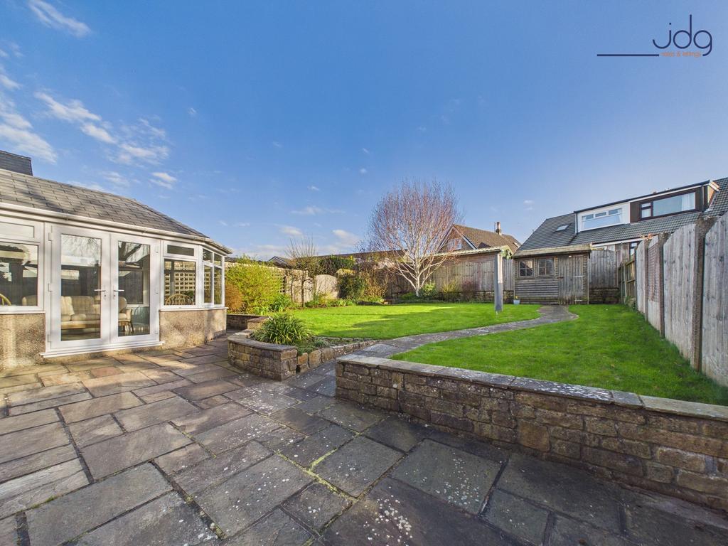 Spacious Garden with a mixture of flags, grass...