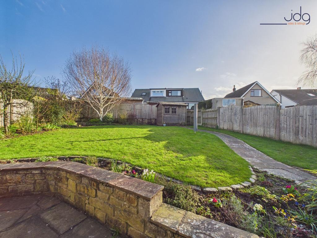 Spacious Garden with a mixture of flags, grass...