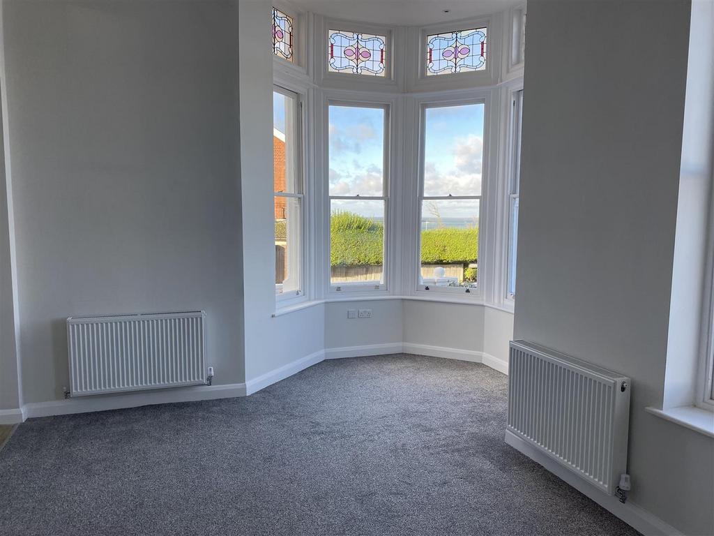 Bright master bedroom with elegant bay windows...