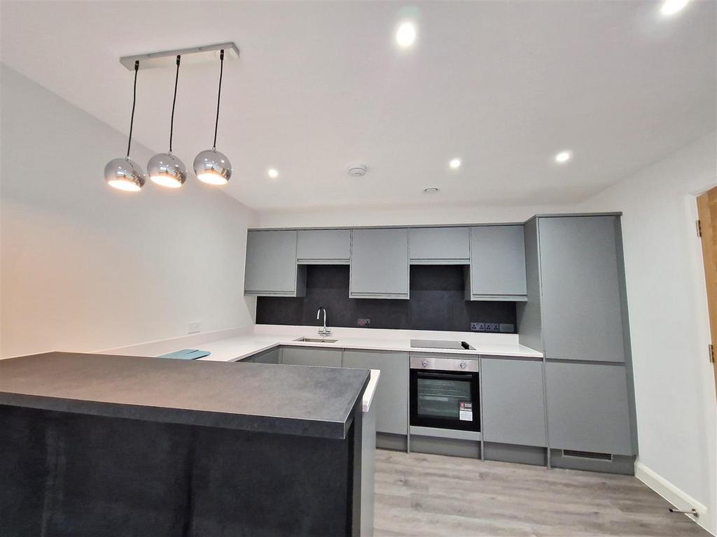 Sleek modern kitchen with stylish grey cabinetr...