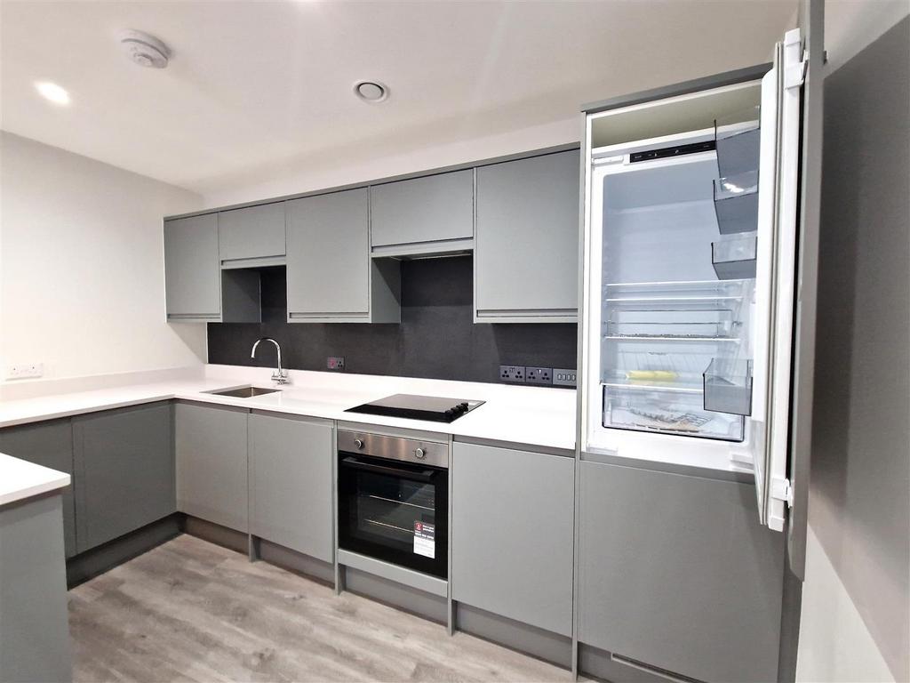 Modern grey kitchen with integrated appliances...