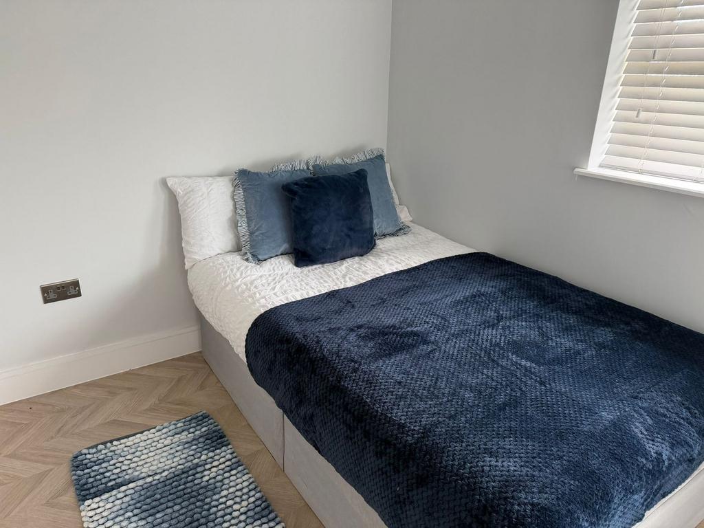 Bright modern bedroom with stylish parquet floo...